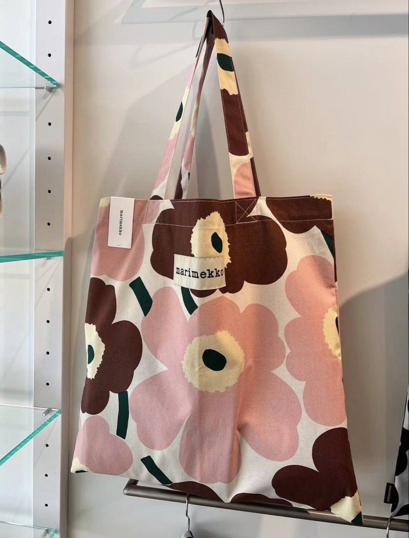 Marimekko Floral Canvas Tote Bag (Category: Tote Bags) located in Makati City. Submitted by ciriacoria (Listing ID 1470054452, Image 1). Description: - Authentic Marimekko canvas tote bag - Iconic pink and brown floral pattern with front brand patch - Brand new with original paper store tag attached - Large main compartment with sturdy, comfortable shoulder straps - Versatile everyday bag ideal for books, groceries, or daily essentials - Rushed s