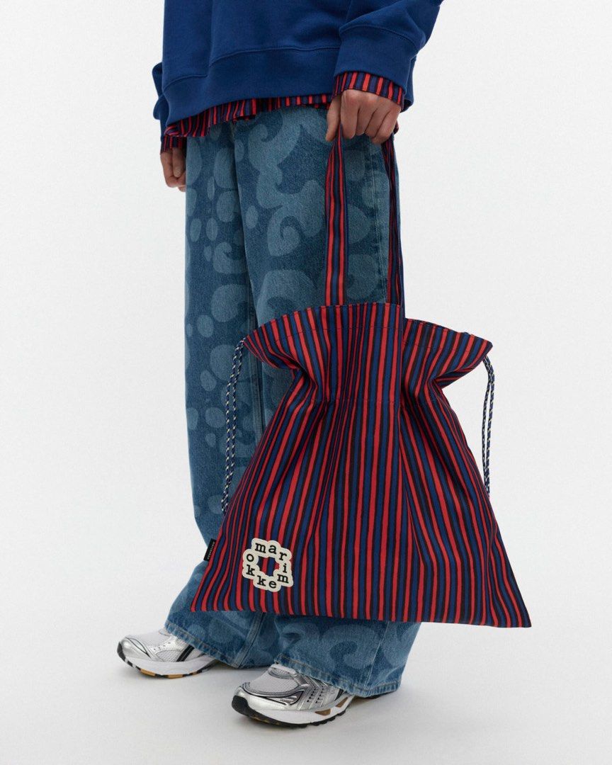 Marimekko Striped Tote Bag Red Blue (Category: Tote Bags) located in Makati City. Submitted by ciriacoria (Listing ID 1470054297, Image 1). Description: - Brand: Marimekko - Design: Red and blue vertical stripes with unique front logo patch - Closure: Drawstring top cinches shut for security - Straps: Comfortable twin shoulder straps - Material: Lightweight fabric construction - Use: Great daily carryall for groceries, books, or essentials - Cond