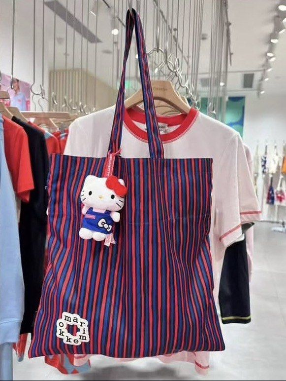 Marimekko Striped Tote Bag Red Blue (Category: Tote Bags) located in Makati City. Submitted by ciriacoria (Listing ID 1470054297, Image 3). Description: - Brand: Marimekko - Design: Red and blue vertical stripes with unique front logo patch - Closure: Drawstring top cinches shut for security - Straps: Comfortable twin shoulder straps - Material: Lightweight fabric construction - Use: Great daily carryall for groceries, books, or essentials - Cond
