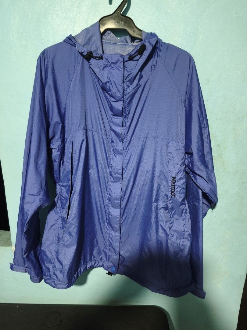 Marmot Blue Hooded Windbreaker Jacket (Category: Coats, Jackets and Outerwear) located in Cavite. Submitted by billcleantone (Listing ID 1470081321, Image 1). Description: - Brand: Marmot - Color: Vibrant blue - Material: Lightweight ripstop fabric - Closure: Full zip front with hidden snap-button placket - Hood: Attached with adjustable drawcords - Hem: Adjustable drawcord to seal out wind - Details: Embroidered Marmot logo on front lower left, 