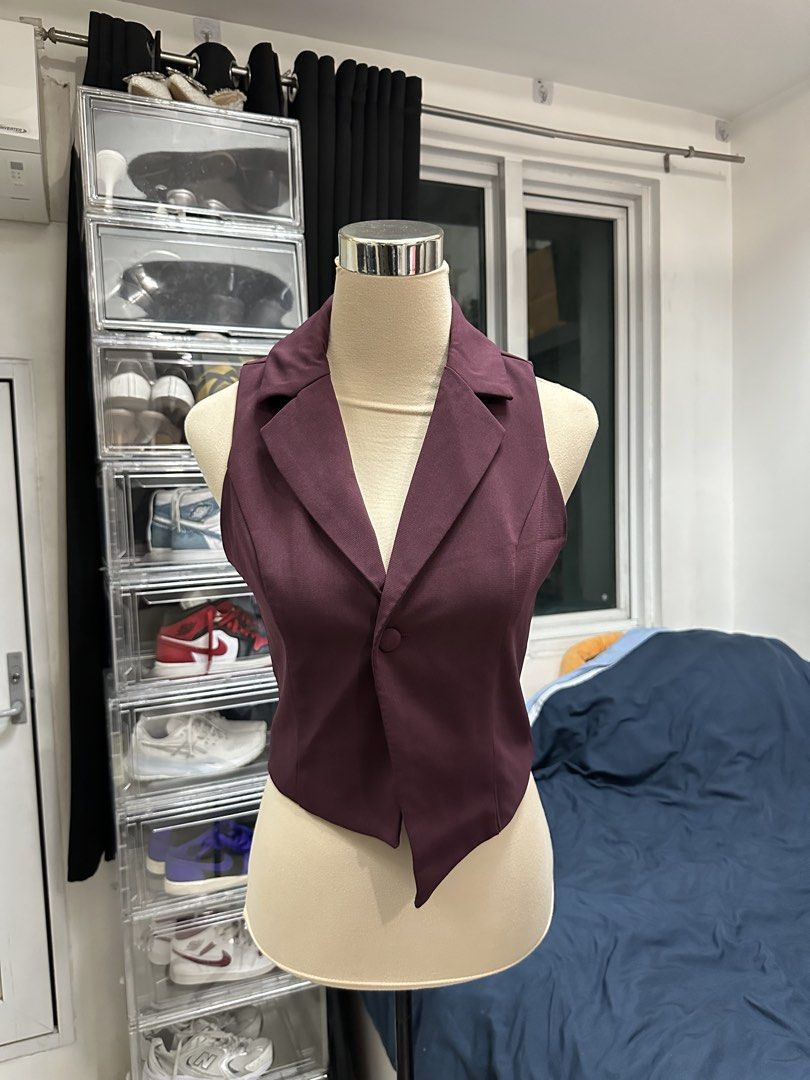 Maroon Asymmetrical Button-Front Vest (Category: Sleeveless) located in Quezon City. Submitted by valeriorac74670 (Listing ID 1470045676, Image 2). Description: - Color: Deep maroon - Design: Sleeveless with lapel collar - Closure: Single front button - Hemline: Asymmetrical (dips down on one side) - Fit: Tailored through the torso - Fabric: Smooth, solid material.