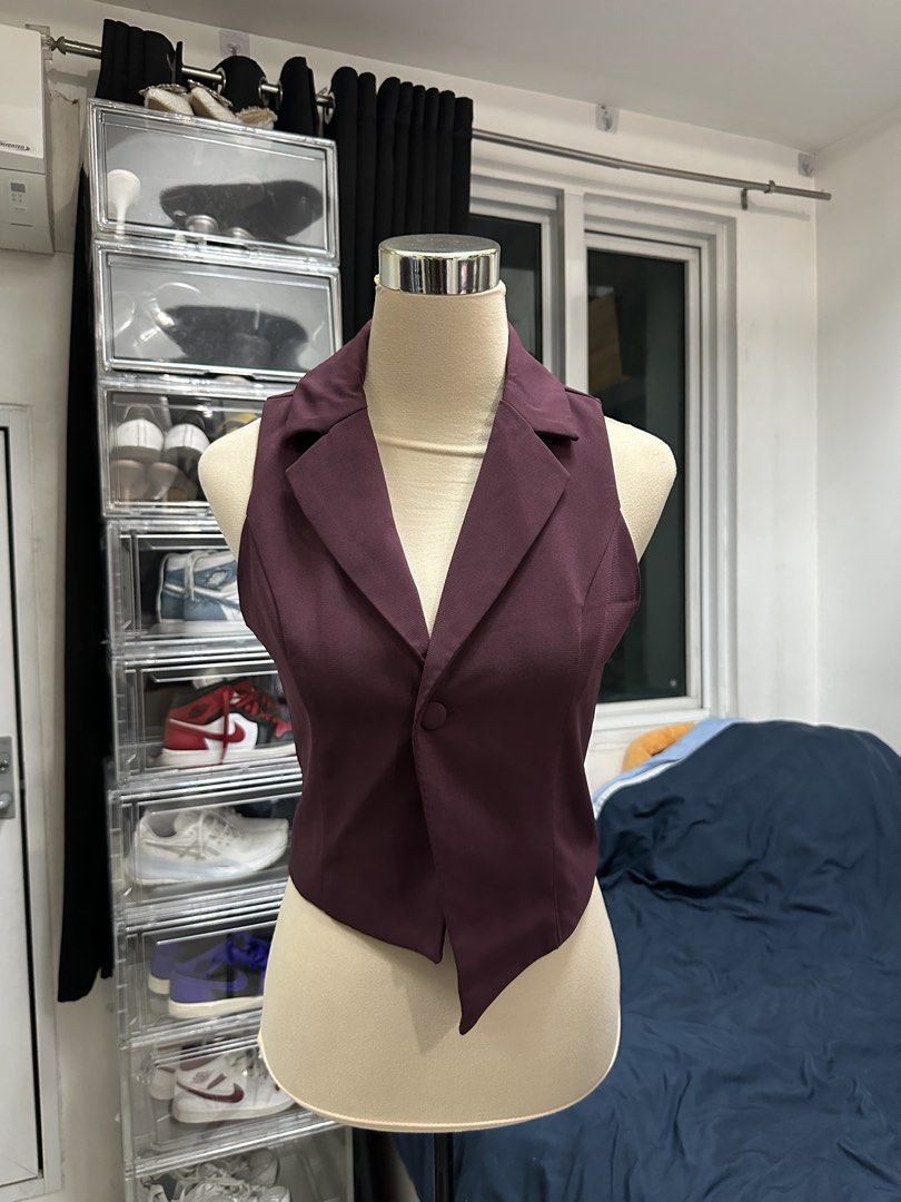 Maroon Asymmetrical Button-Front Vest (Category: Sleeveless) located in Quezon City. Submitted by valeriorac74670 (Listing ID 1470045676, Image 1). Description: - Color: Deep maroon - Design: Sleeveless with lapel collar - Closure: Single front button - Hemline: Asymmetrical (dips down on one side) - Fit: Tailored through the torso - Fabric: Smooth, solid material.