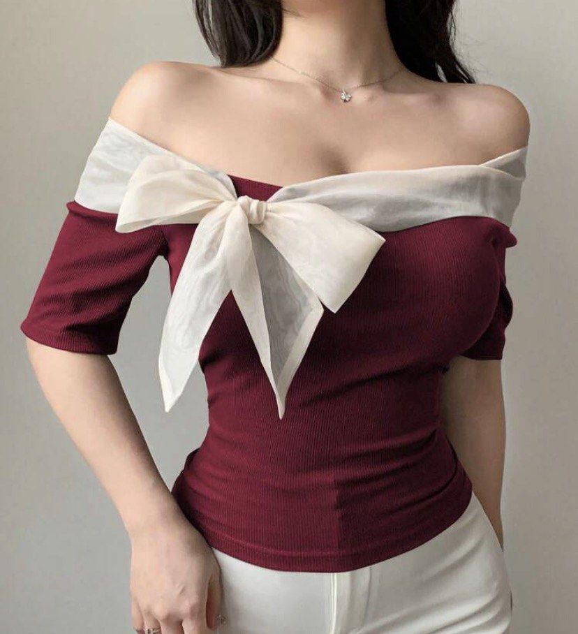 Maroon Off-Shoulder Top with White Bow (Category: Blouses) located in Las Pinas. Submitted by sxo.seya (Listing ID 1469974957, Image 1). Description: - Color: Maroon with white contrast trim - Style: Off-shoulder, short sleeves, fitted silhouette - Feature: Large white fabric bow tied on the front - Material: Comfortable ribbed fabric - Condition: Excellent / Like new - Styling tip: Pairs perfectly with white pants for a stylish look - Meet-ups a