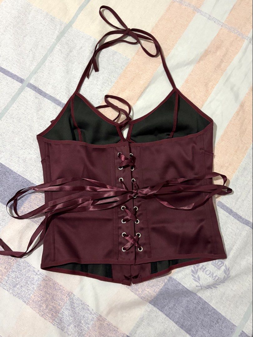 Maroon Satin Halter Corset Top Lace-Up Back (Category: Sleeveless) located in Las Pinas. Submitted by hanrue12 (Listing ID 1469955039, Image 2). Description: - RFS: Wrong size - Color & Material: Rich maroon satin with a soft, comfortable inner lining - Design: Halter straps, sweet front bow tie, and structured front boning for a flattering fit - Closure: Adjustable lace-up ribbon back for easy sizing - Condition: Never worn outside, excellent br
