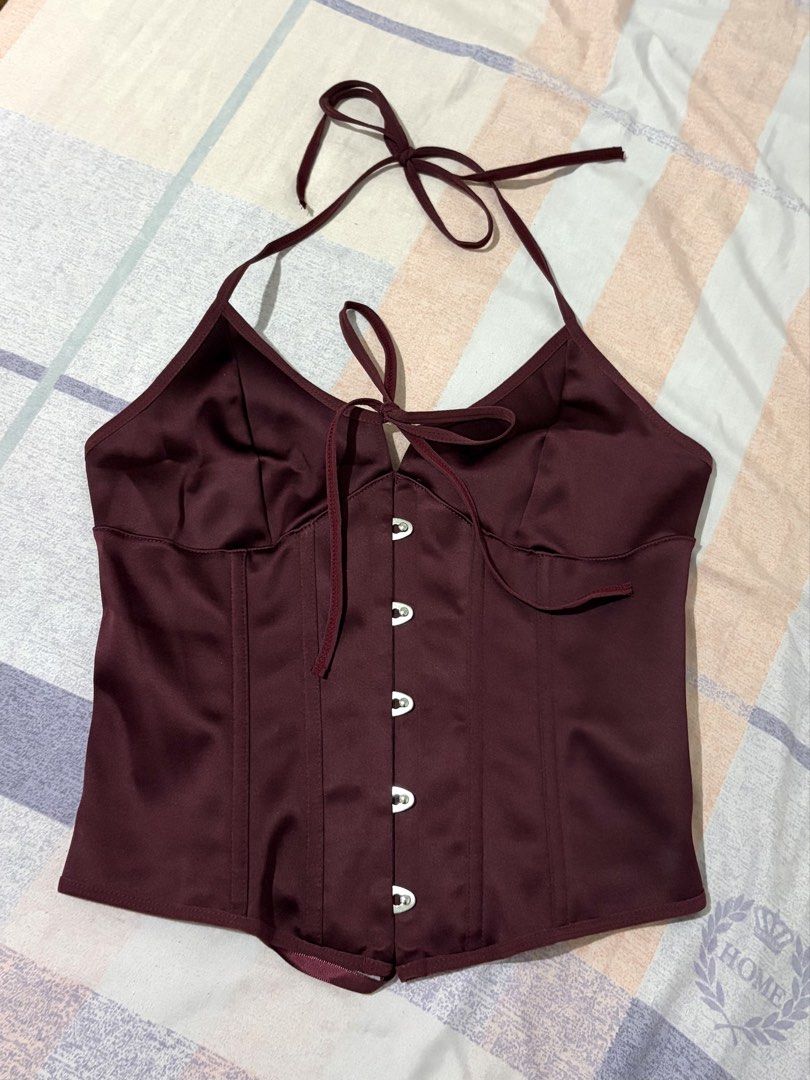 Maroon Satin Halter Corset Top Lace-Up Back (Category: Sleeveless) located in Las Pinas. Submitted by hanrue12 (Listing ID 1469955039, Image 1). Description: - RFS: Wrong size - Color & Material: Rich maroon satin with a soft, comfortable inner lining - Design: Halter straps, sweet front bow tie, and structured front boning for a flattering fit - Closure: Adjustable lace-up ribbon back for easy sizing - Condition: Never worn outside, excellent br