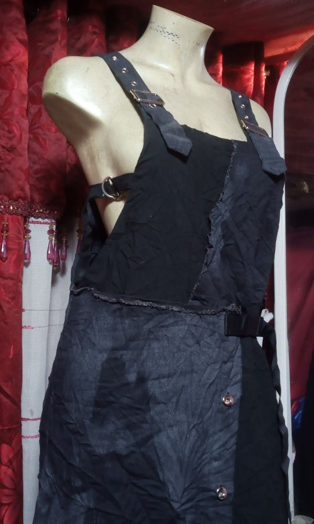 Maxi jumpsuit (Category: Jumpsuits) located in Manila. Submitted by wheneity67thifted (Listing ID 1470136446, Image 3). Description: The image shows a black denim or cotton overall-style maxi dress featuring an asymmetrical wrap-and-button front, distressed raw seams, and buckle shoulder straps..