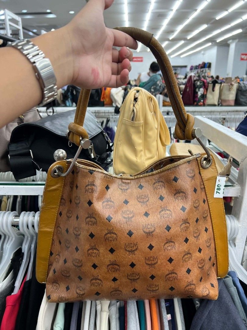 MCM Visetos Monogram Bucket Handbag (Category: Luxury Bags & Wallets) located in Urdaneta. Submitted by jayceegarage (Listing ID 1470096682, Image 2). Description: - Brand: MCM - Style: Bucket Handbag - Material: Classic Visetos monogram coated canvas with tan leather trim - Hardware: Gold-tone metal details with front lock accent and MCM München metal plaque - Features: Structured shape, single top grab handle, and dark interior lining - Conditi