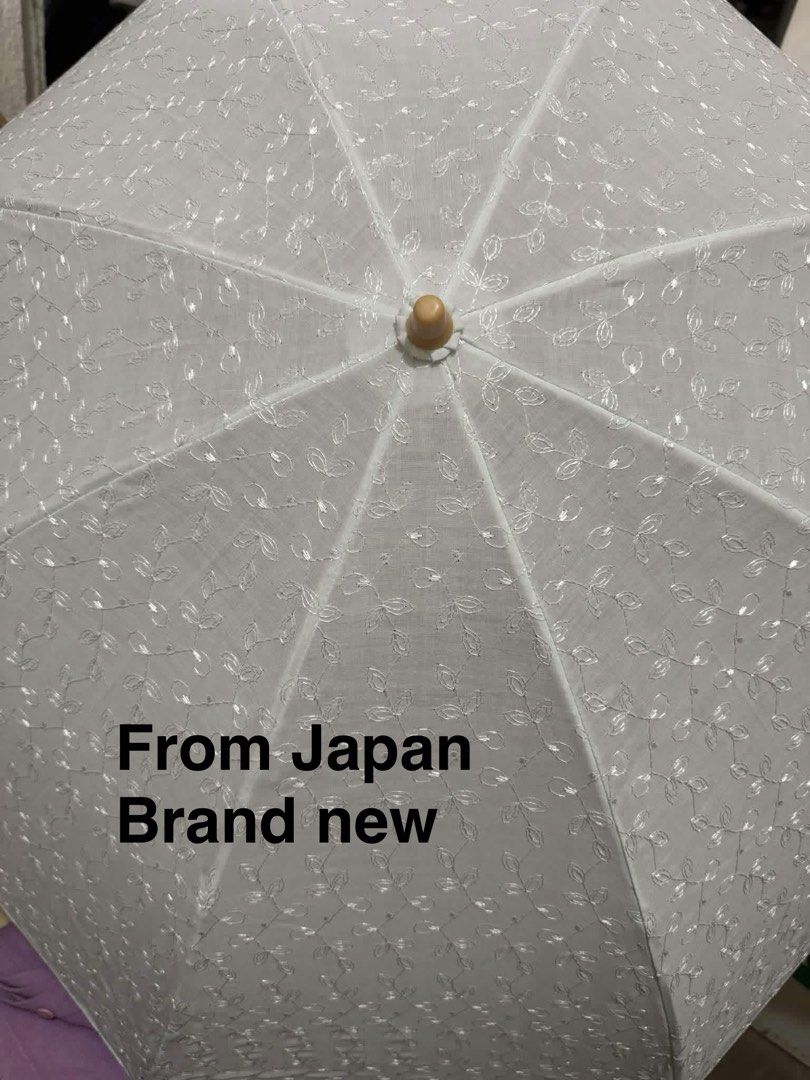 Menard UV-Processed Folding Sun Umbrella (Category: Umbrellas) located in Quezon City. Submitted by bluefrenchorn (Listing ID 1470067663, Image 2). Description: - Brand: Menard (Direct import from Japan) - Model: Elegance parasol - Design: White fabric with delicate embroidered leaf patterns - Features: UV-processed folding sun umbrella with wooden handle and wrist strap - Condition: Unused and brand new - Inclusions: Original matching box and pr