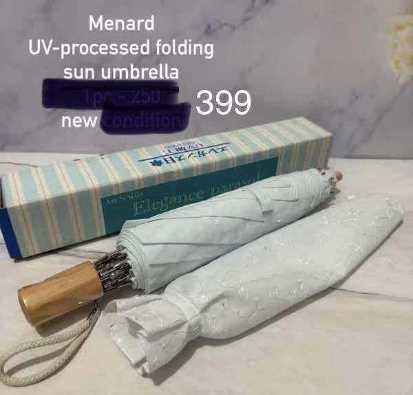 Menard UV-Processed Folding Sun Umbrella (Category: Umbrellas) located in Quezon City. Submitted by bluefrenchorn (Listing ID 1470067663, Image 1). Description: - Brand: Menard (Direct import from Japan) - Model: Elegance parasol - Design: White fabric with delicate embroidered leaf patterns - Features: UV-processed folding sun umbrella with wooden handle and wrist strap - Condition: Unused and brand new - Inclusions: Original matching box and pr