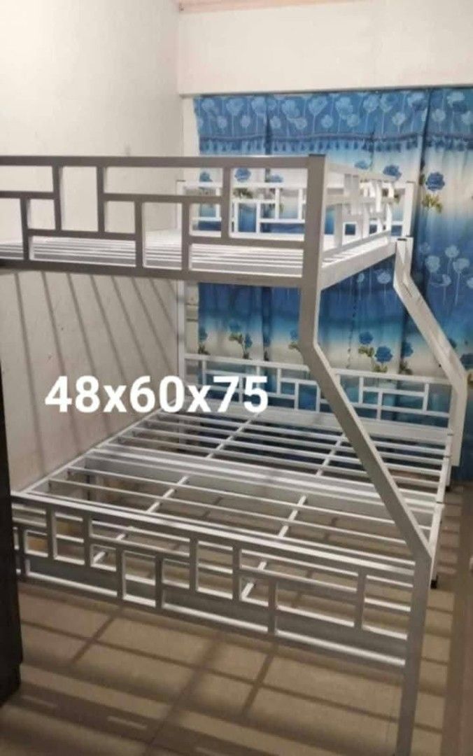 Metal Bunk Bed Double Over Single Space Saving (Category: Bed Frames & Mattresses) located in Manila. Submitted by joydejuan22 (Listing ID 1470023347, Image 2). Description: - Heavy-duty metal bunk bed frame in a sleek matte black finish - Space-saving design: Double bed (bottom) and single bed (top) - Safe and stylish geometric guardrail design on the upper bunk and headboard - Built-in side ladder for easy access - Sturdy metal slat support for