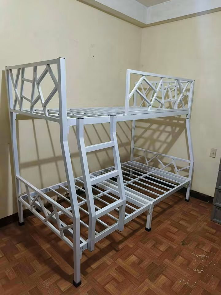 Metal Bunk Bed Double Over Single Space Saving (Category: Bed Frames & Mattresses) located in Manila. Submitted by joydejuan22 (Listing ID 1470023347, Image 3). Description: - Heavy-duty metal bunk bed frame in a sleek matte black finish - Space-saving design: Double bed (bottom) and single bed (top) - Safe and stylish geometric guardrail design on the upper bunk and headboard - Built-in side ladder for easy access - Sturdy metal slat support for