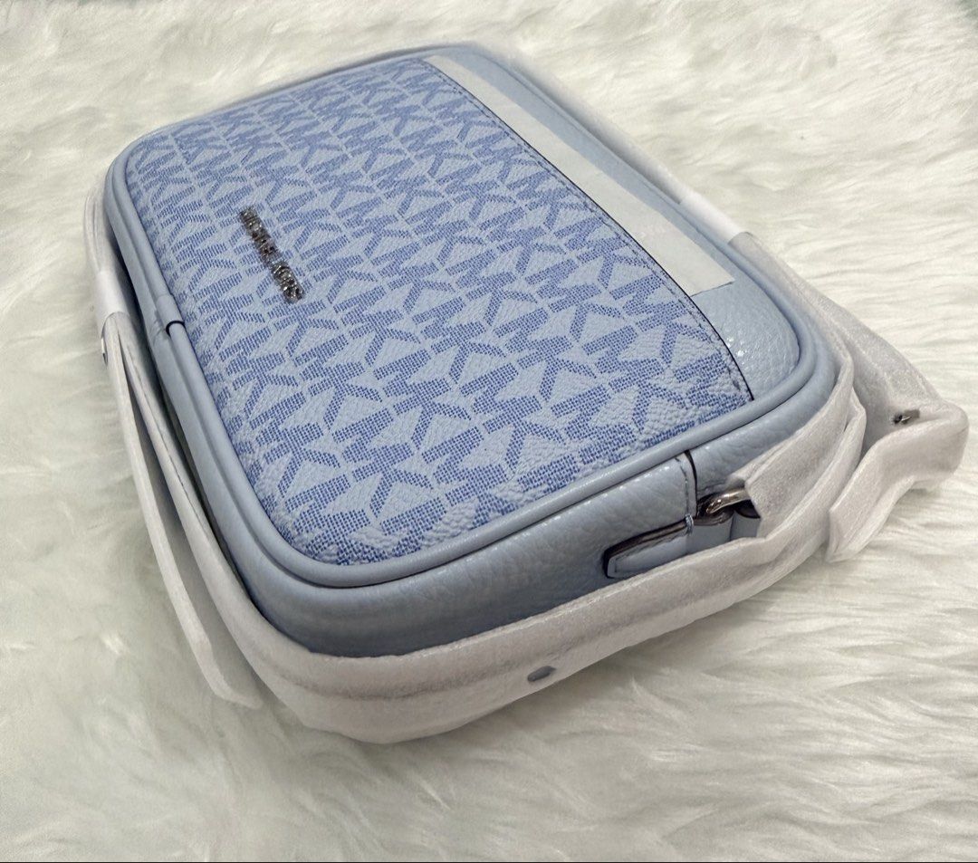 Michael Kors Blue Jet Set Small Camera Bag (Category: Cross-body Bags) located in Manila. Submitted by shobeybe08 (Listing ID 1469952448, Image 2). Description: MICHAEL KORS JET SET SMALL CAMERA BAG Brandnew 💯AUTHENTIC Bought in US 🇺🇸 Money back guarantee Onhand and ready to ship Open for layaway Lalamove ready/LBC/J&T Loc: MANILA DM for inquiries 🫶 - Brand: Michael Kors - Design: Light blue and white MK monogram print with smooth blue leathe