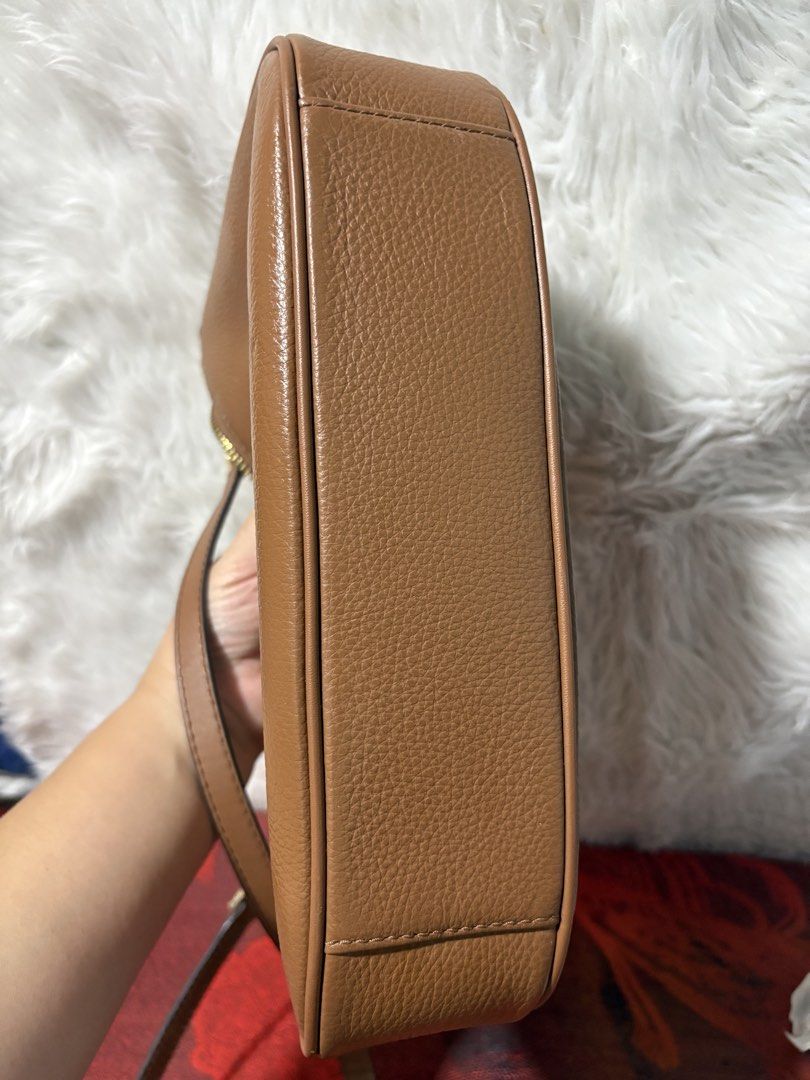 Michael Kors Brown Leather Shoulder Bag (Category: Luxury Bags & Wallets) located in Manila. Submitted by orallojani39622 (Listing ID 1470081298, Image 3). Description: - Brand: Michael Kors - Material: Tan pebble leather with gold-tone hardware - Closure: Secure top zip closure - Interior: Clean MK signature fabric lining with convenient slip pockets - Strap: Includes a removable and adjustable strap for versatile styling - Condition: Excellent,
