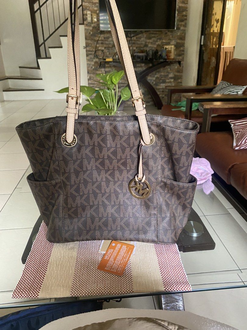Michael Kors Brown Monogram Tote Bag (Category: Tote Bags) located in Manila. Submitted by lanna.307 (Listing ID 1470037511, Image 2). Description: - Authentic Brown Michael Kors Monogram Tote Bag - Classic tan leather straps and elegant gold-tone hardware - Dual shoulder straps for comfortable daily wear - Signature front hanging logo charm - Convenient exterior side slip pockets - Spacious interior to fit your daily essentials - with authentica