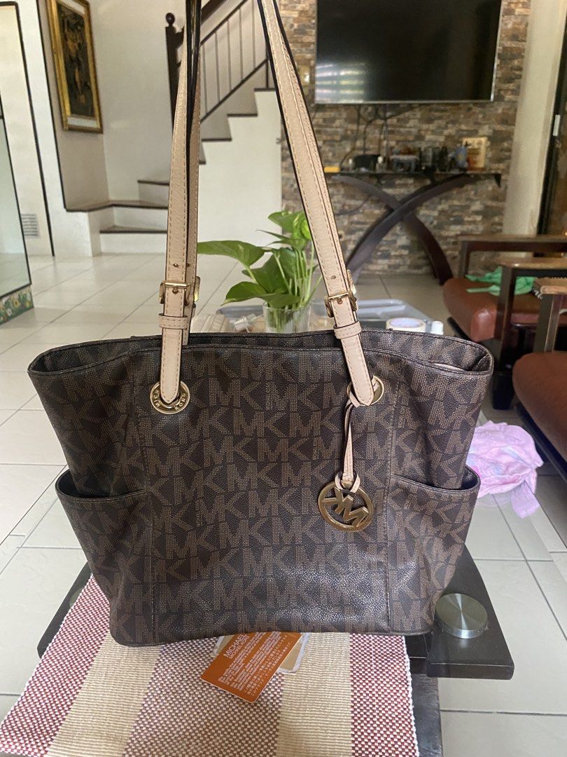Michael Kors Brown Monogram Tote Bag (Category: Tote Bags) located in Manila. Submitted by lanna.307 (Listing ID 1470037511, Image 1). Description: - Authentic Brown Michael Kors Monogram Tote Bag - Classic tan leather straps and elegant gold-tone hardware - Dual shoulder straps for comfortable daily wear - Signature front hanging logo charm - Convenient exterior side slip pockets - Spacious interior to fit your daily essentials - with authentica