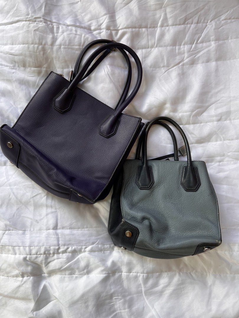 Michael Kors Handbag Lot Two Totes (Category: Tote Bags) located in Manila. Submitted by mightylion-ce6ea7 (Listing ID 1470032028, Image 2). Description: - Authentic Michael Kors Tote Bag Bundle (Set of 2) - Bag 1: Purple textured leather with metal eyelet grommets, diamond patterns, and hanging padlock charm - Bag 2: Dual-tone blue and black pebbled leather with silver padlock accent - Storage: Both feature secure zippered middle compartments an