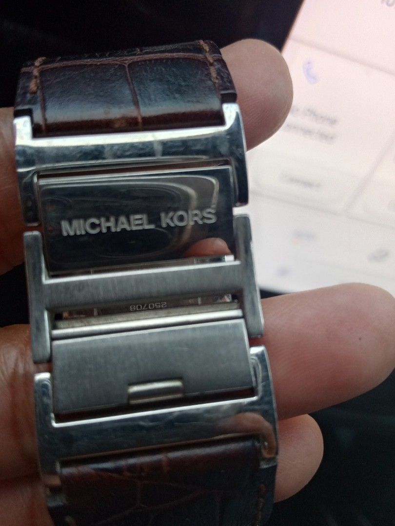 Michael Kors MK-4134 Square Dial Watch Brown Leather Strap (Category: Women's Watches) located in Malolos. Submitted by lizarondoe59660 (Listing ID 1470048418, Image 2). Description: - Brand: Michael Kors - Model: MK-4134 (Serial: 250708) - Dial: Square silver dial with date display - Strap: Brown embossed leather with branded MK metal hardware accents - Case Back: Stainless steel - Water Resistance: 5 ATM - Condition: Shows light surface scratch