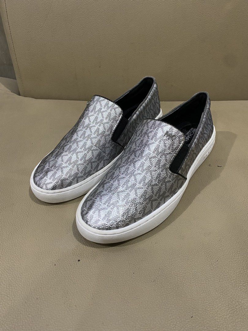 Michael Kors monogram Silver MK Logo Slip-On Sneakers (Category: Sneakers) located in Digos. Submitted by zhanderapp47607 (Listing ID 1470111051, Image 2). Description: - Brand: Michael Kors - Style: Slip-on platform sneakers - Color/Design: Silver metallic with all-over MK logo pattern - Soles: White rubber platform with side branding very clean - Comfort: Elastic side gore panels for easy slip-on and secure fit - Condition: Excellent to new con
