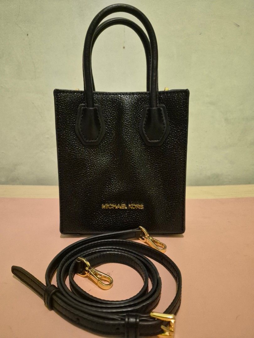 Michael Kors Pebbled Leather Phone Sling Bag (Category: Cross-body Bags) located in Quezon City. Submitted by gbabesy (Listing ID 1470141536, Image 2). Description: Seasonal decluttering ✨️ Michael Kors black pebbled leather mini bag/ CP sling bag - Features top handles and a detachable crossbody strap - Elegant gold hardware details - Interior pockets/card slots for organization - Minor sign of usage on sling (small dents only, not chaffings or 
