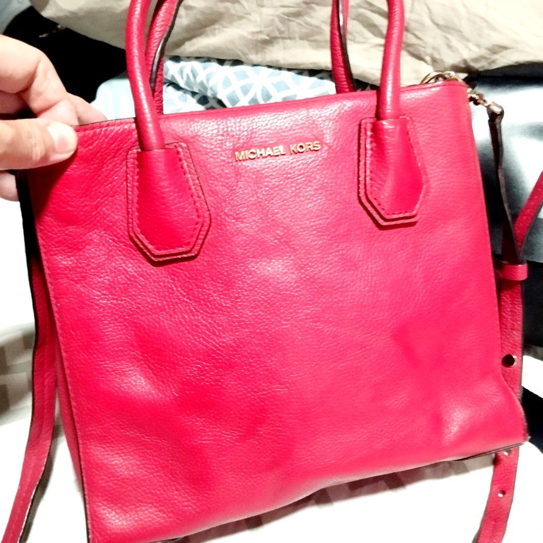 Michael Kors Red Leather Tote Bag (Category: Tote Bags) located in Manila. Submitted by lene48 (Listing ID 1469966390, Image 1). Description: - Brand: Michael Kors - Material: Premium red pebbled leather - Hardware: Elegant gold-tone accents - Storage: Spacious interior with a center zipped compartment and multiple slip pockets - Carry options: Double top handles and an adjustable shoulder strap - Protection: Metal feet on the base - Condition: E