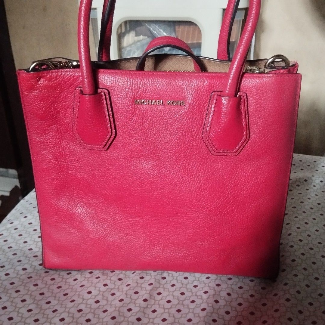 Michael Kors Red Leather Tote Bag (Category: Tote Bags) located in Manila. Submitted by lene48 (Listing ID 1469966390, Image 2). Description: - Brand: Michael Kors - Material: Premium red pebbled leather - Hardware: Elegant gold-tone accents - Storage: Spacious interior with a center zipped compartment and multiple slip pockets - Carry options: Double top handles and an adjustable shoulder strap - Protection: Metal feet on the base - Condition: E