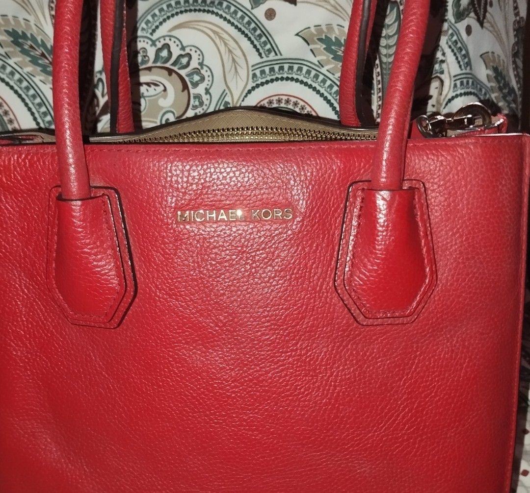 Michael Kors Red Leather Tote Bag (Category: Tote Bags) located in Manila. Submitted by lene48 (Listing ID 1470088585, Image 1). Description: - Brand: Michael Kors - Material: Bright red pebble leather with gold hardware - Closure & Handles: Top zip closure, dual top handles, and a detachable/adjustable shoulder strap - Interior: Fabric-lined with a zip pocket and metal logo plaque - Protection: Metal feet on the base - Versatility: Vibrant state
