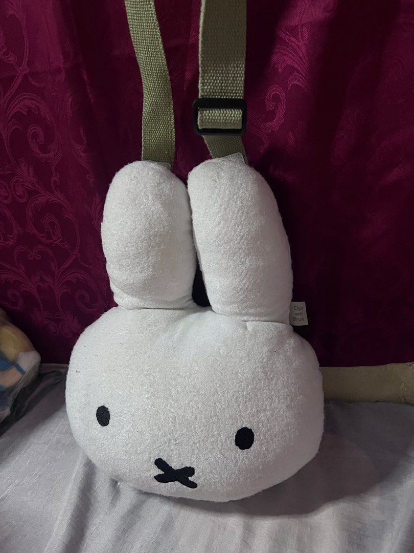 Miffy plush face crossbody bag white (Category: Cross-body Bags) located in Bulacan. Submitted by haven_plushie_dolls.888 (Listing ID 1470103963, Image 2). Description: - Authentic Miffy plush face crossbody bag - Soft towel-like fabric material in clean condition - Adjustable green canvas strap with buckle closure - Features 'Enjoy with Bruna' and Mercis bv tag - Perfect cute accessory for daily use or casual outings - need wash.