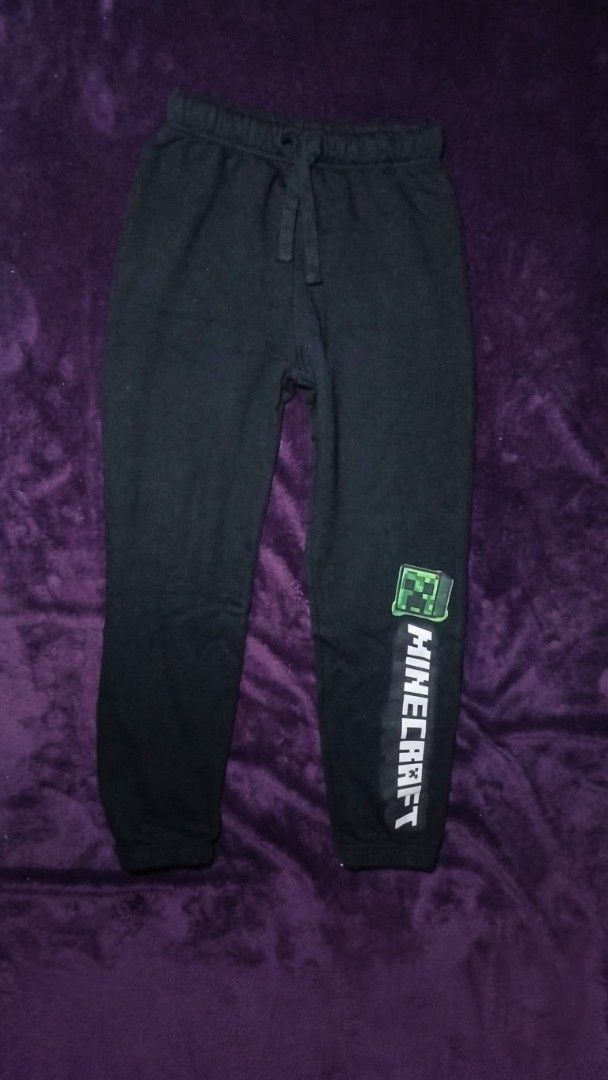 Minecraft Black Joggers Sweatpants With Creeper Graphic (Category: Joggers) located in Caloocan City. Submitted by yat0zu (Listing ID 1470087188, Image 1). Description: - Color: Black - Design: Green Creeper face graphic with vertical white Minecraft lettering on the left leg - Material: Soft fleece, perfect for daily lounging or gaming - Features: Elastic waistband with matching black drawstring, ribbed ankle cuffs - Fit: Easy pull-on style for 