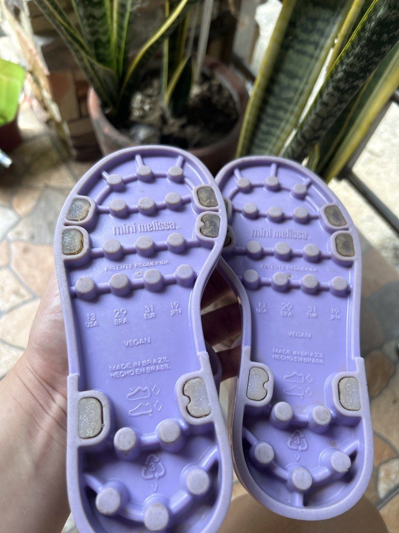 Mini Melissa Purple Star Sandals Size 13 US (Category: Babies & Kids Fashion) located in Gapan. Submitted by mysticrabbit-3195 (Listing ID 1469968666, Image 3). Description: - Brand: Mini Melissa - Color: Purple with glittery star straps - Closure: Easy hook-and-loop ankle strap - Material: Vegan, made in Brazil - Size: USA 13, EUR 31, BRA 29, JPN 19 - Condition: Clean footbeds with visible branding.