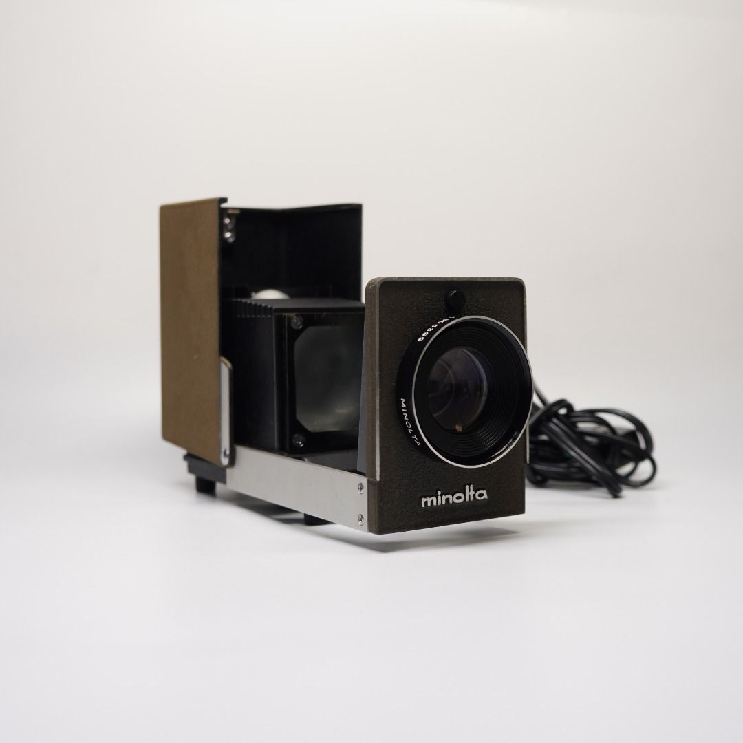 MINOLTA MINI-35 — 35MM SLIDE PROJECTOR (Category: Projectors) located in Las Pinas. Submitted by retrocameraph (Listing ID 1470106240, Image 1). Description: 📽️ MINOLTA MINI-35 — 35MM SLIDE PROJECTOR A vintage Minolta waiting for its next chapter! ✨ • P-Rokkor 75mm f/2.5 projection lens • Clean lens and presentable overall condition • Great for display, collecting, or future restoration ⚠️ Bulb is busted and needs replacement. Projection functio
