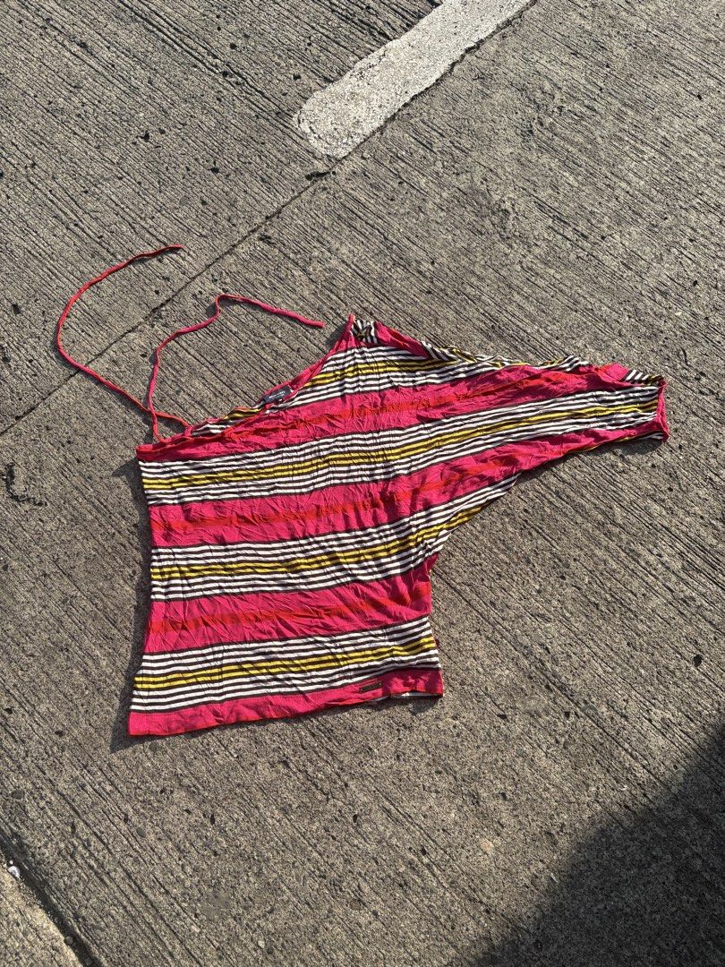 Miss Sixty Multi-color Striped One-shoulder Top (Category: Blouses) located in Iligan City. Submitted by seddicmoti2002 (Listing ID 1470138729, Image 1). Description: - Brand: Miss Sixty - Size: S (fits true to size) - Design: Asymmetric one-shoulder with halter tie strap and draped sleeve - Pattern: Bright pink, yellow, brown, and white stripes - Material: Lightweight knit fabric - Detail: Metal logo tag near the bottom hem - Condition: Great ca