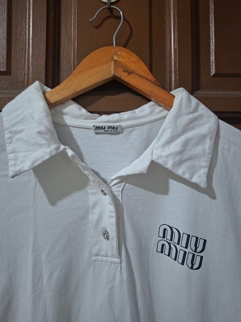 Miu Miu White Polo Shirt (Category: Shirts) located in Quezon City. Submitted by shawnstussy (Listing ID 1470041115, Image 2). Description: - Brand: Miu Miu - Item: White Polo Shirt - Size: S - Material: 100% Cotton - Origin: Made in Italy - Features: Short sleeves, collar neck, front button placket, and Miu Miu chest logo - Care: Gentle hand wash recommended.