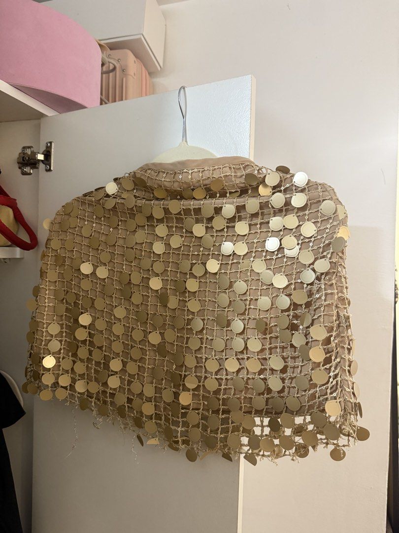 Miu the label ibiza skirt (Category: Sleeveless) located in Quezon City. Submitted by wardrobetreasuresx (Listing ID 1470046567, Image 1). Description: - Stunning gold sequin mesh shawl for parties and evening events - Light beige open-weave crochet fabric covered in shiny round gold sequins - Elegant fringe detail along the bottom edge - Lightweight layering piece that drapes nicely over outfits.