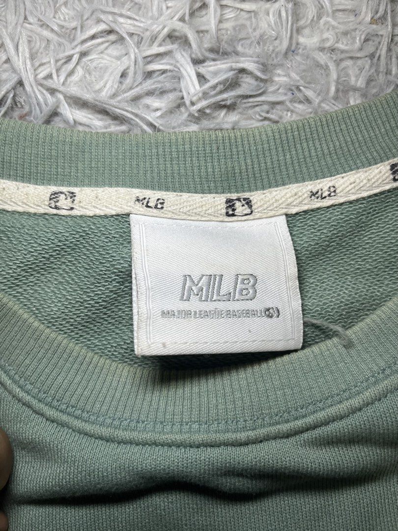 MLB Green Sweatshirt with Graffiti C Logo (Category: Coats, Jackets and Outerwear) located in Muntinlupa City. Submitted by pastforwardthrift (Listing ID 1470126313, Image 3). Description: - Color: Washed sage green - Size: L (Relaxed fit pullover) - Design: Small 'C' logo on chest and right sleeve, large graffiti-style 'C' graphic on the back - Details: Crewneck collar with official MLB branded inner taping and neck tags.
