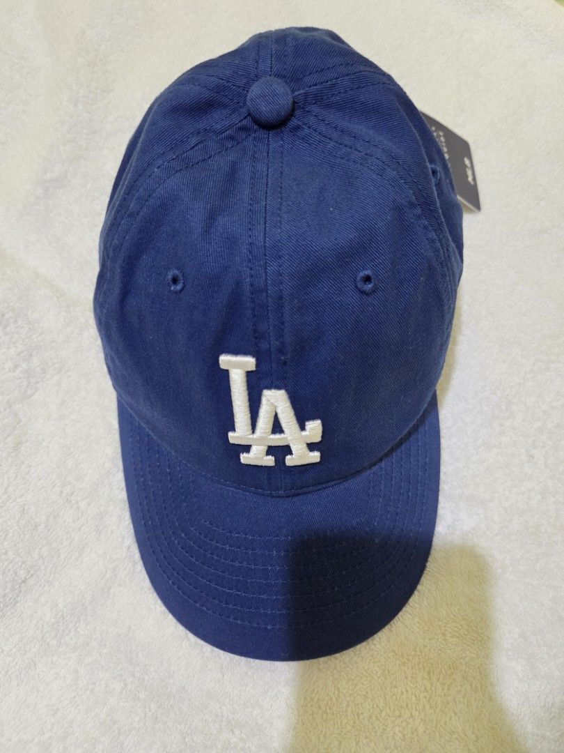MLB Los Angeles Dodgers Navy Blue Cap Hat (Category: Caps & Hats) located in Abucay. Submitted by stripesandcheck (Listing ID 1470039674, Image 1). Description: - Authentic MLB Los Angeles Dodgers cap - Color: Dark navy blue with white embroidered LA logo - Condition: Brand new, unworn with original tags attached - Closure: Adjustable metal strap with MLB branding - Perfect for everyday wear or game days MLB not New Era.