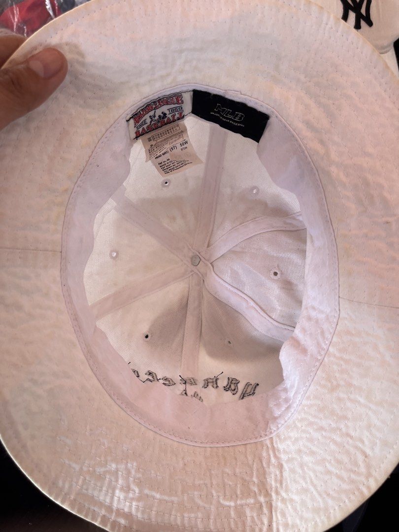 MLB New York Yankees White Bucket Hat (Category: Caps & Hats) located in Pilar. Submitted by fast-flip-ni-miko. (Listing ID 1469989522, Image 3). Description: - Brand: MLB (Major League Baseball) - Team: New York Yankees (front lettering and classic NY logo) - Color: White - Size: Head girth 57 (50W) - Condition: Pre-loved with noticeable yellowing and discoloration on the brim and crown - Details: Interior branding tags intact, great casual stre