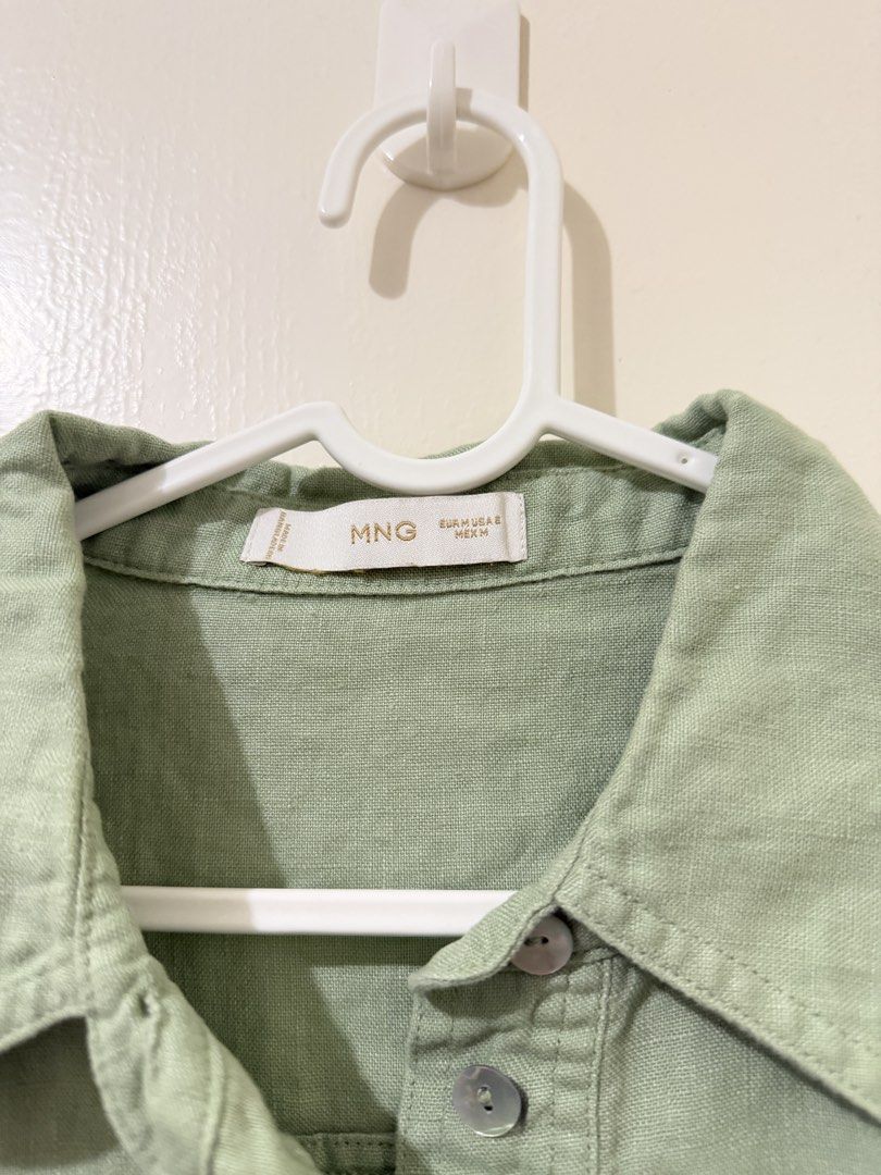 MNG Green Short Sleeve Collared Shirt Size M (Category: Shirts) located in Pasay City. Submitted by triciasclosetph (Listing ID 1470067112, Image 2). Description: - Brand: MNG - Color: Sage Green - Size: Medium (fits EUR, USA, MEX Medium) - Style: Short sleeve, button-up, collared neckline, cropped length - Material: Soft woven texture - Condition: Great basic piece for casual wear or layering - Origin: Made in Bangladesh.
