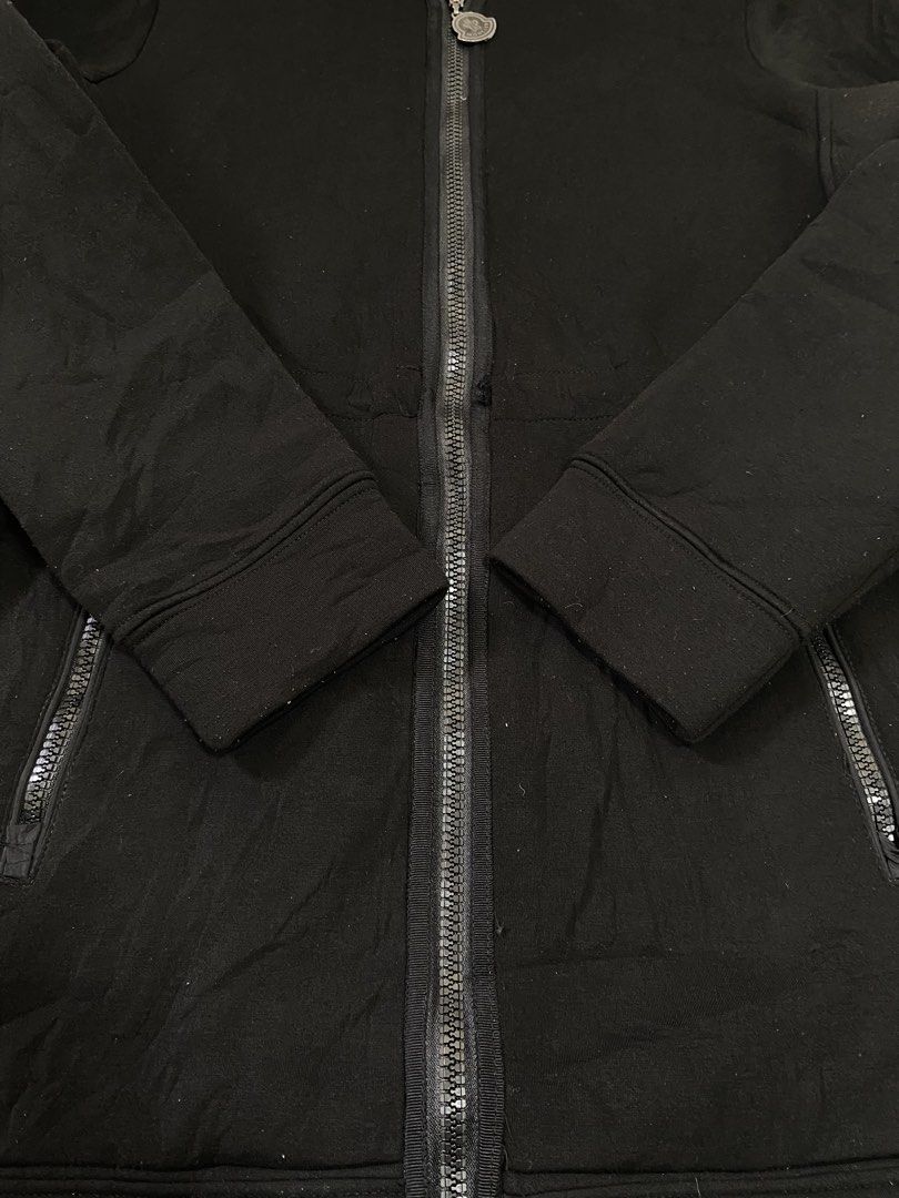 Moncler Black Zip Hoodie with Ruffled Hem (Category: Coats, Jackets and Outerwear) located in Manila. Submitted by refit_thrifts_ (Listing ID 1469985992, Image 2). Description: - Brand: Moncler - Color: Classic Black - Style: Hooded zip jacket with chic ruffle trim along the hood and bottom hem - Hardware: Branded metal zipper pull - Pockets: Two secure zipped lower pockets - Details: Adjustable hood drawstrings and comfortable ribbed cuffs - Fla