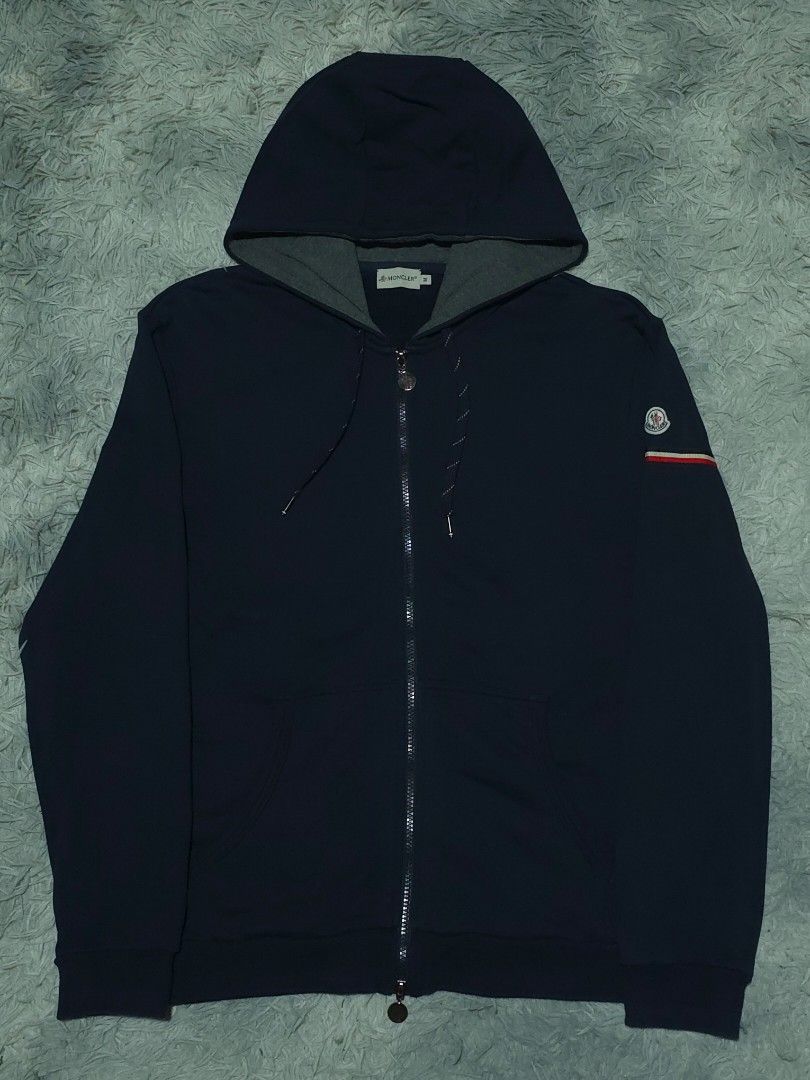 Moncler Navy Blue Zip-up Hoodie (Category: Hoodies) located in Abulug. Submitted by humanwhosellthings (Listing ID 1469988593, Image 1). Description: Size Medium on tag fit to Large 21W x 27L Excellent Condition No issue.