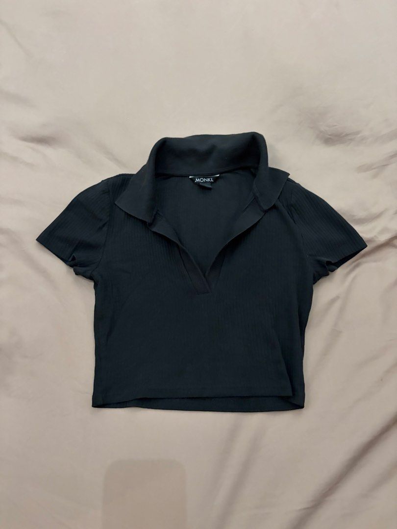 Monki Polo Crop Top (Category: Shirts) located in Pasig City. Submitted by gdeclutterwithme (Listing ID 1470124493, Image 1). Description: - Brand: Monki - Style: Black ribbed polo crop top with short sleeves - Neckline: V-neck collar design - Fabric: Stretchy and comfortable - Fit: Crop top, perfect to pair with high-waisted jeans or skirts - Condition: Clean, simple, and great for everyday wear.