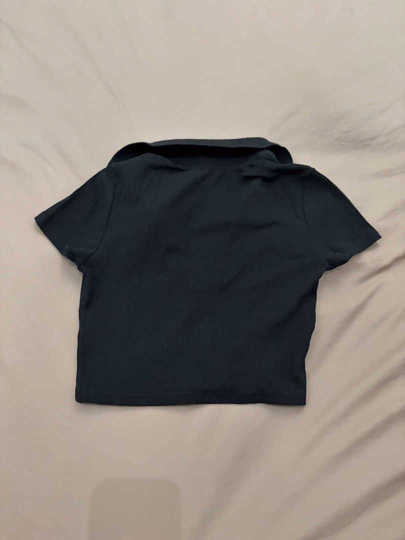 Monki Polo Crop Top (Category: Shirts) located in Pasig City. Submitted by gdeclutterwithme (Listing ID 1470124493, Image 3). Description: - Brand: Monki - Style: Black ribbed polo crop top with short sleeves - Neckline: V-neck collar design - Fabric: Stretchy and comfortable - Fit: Crop top, perfect to pair with high-waisted jeans or skirts - Condition: Clean, simple, and great for everyday wear.