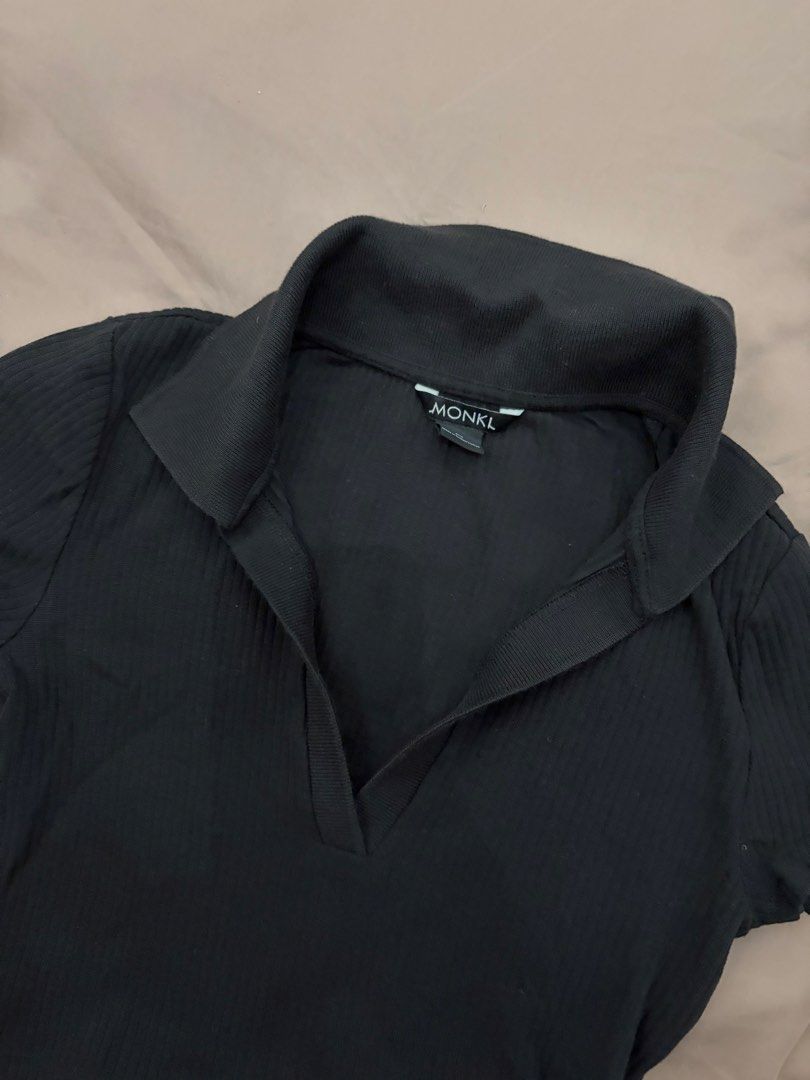 Monki Polo Crop Top (Category: Shirts) located in Pasig City. Submitted by gdeclutterwithme (Listing ID 1470124493, Image 2). Description: - Brand: Monki - Style: Black ribbed polo crop top with short sleeves - Neckline: V-neck collar design - Fabric: Stretchy and comfortable - Fit: Crop top, perfect to pair with high-waisted jeans or skirts - Condition: Clean, simple, and great for everyday wear.