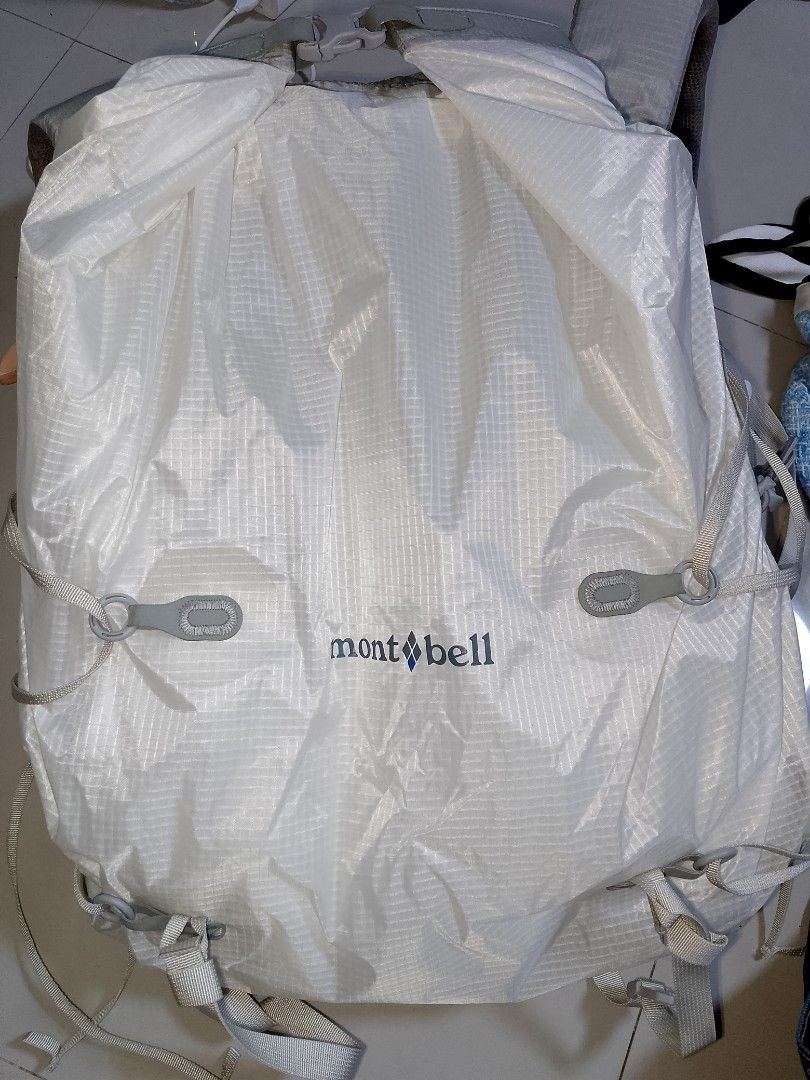 Montbell Altiplano Pack 30 Backpack (Category: Backpacks) located in Manila. Submitted by mjthrifted_second (Listing ID 1469986110, Image 2). Description: - Brand: Montbell - Model: Altiplano Pack 30 - Color: White ripstop fabric - Condition: Clean, hardly any signs of wear - Features: Lightweight design, roll-top with buckle closure, shoulder strap pockets, mesh back panel, and interior zip compartment - Exterior: Multiple adjustment straps and 