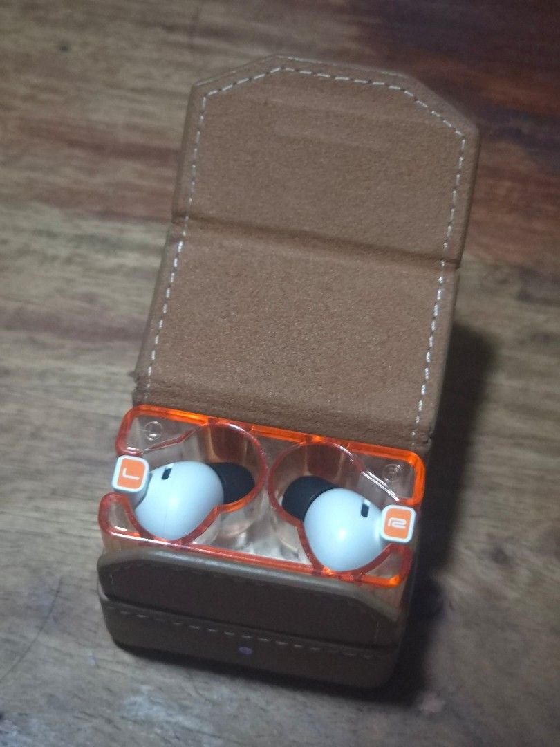 Moondrop Space Travel 2 True Wireless Earbuds (Category: Earphones) located in Quezon City. Submitted by rmdam (Listing ID 1470119516, Image 2). Description: - Model: Moondrop Space Travel 2 wireless earbuds - Colorway: White and orange with a clear charging case design - Condition: Working and in great shape - Includes: Earbuds with black silicone tips plus a premium brown leather-style protective carrying case with debossed Moondrop logo - Feat