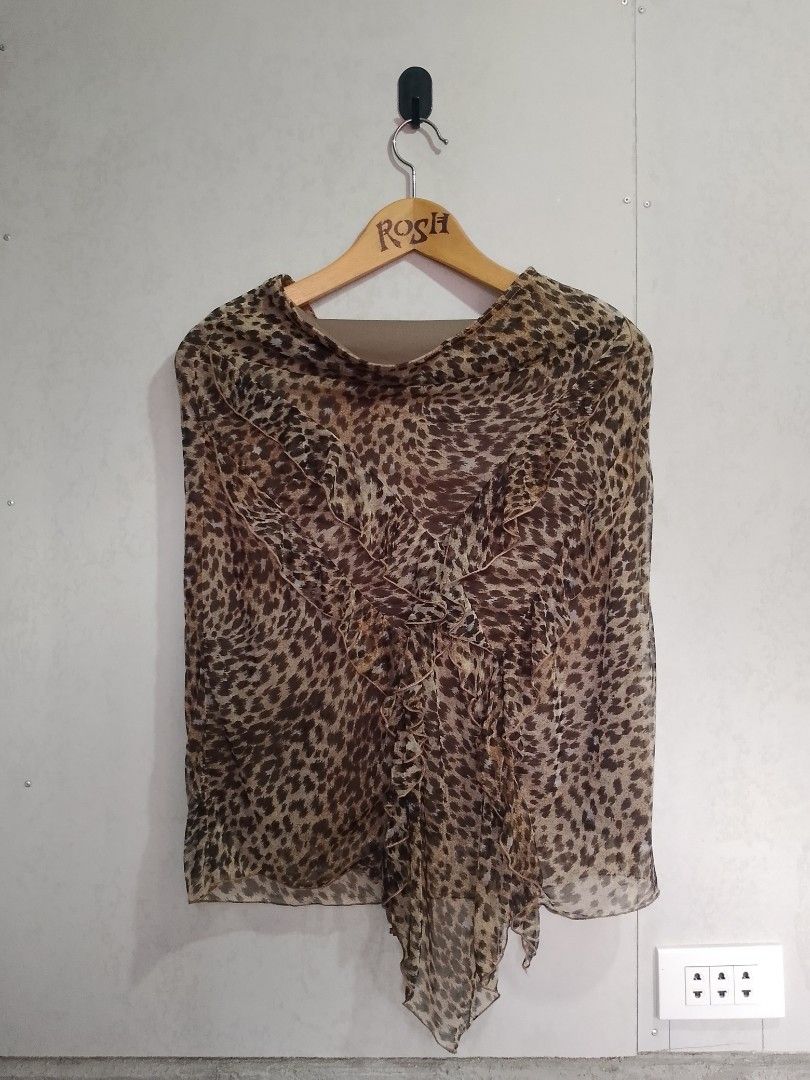 Morgan de Toi Leopard Print Ruffle Blouse (Category: Blouses) located in Manila. Submitted by romeoamoro00044 (Listing ID 1469992720, Image 1). Description: - Brand: Morgan de Toi - Design: Brown and black leopard print sheer chiffon overlay with built-in lining - Details: Statement cascading front ruffles and an asymmetrical pointed hemline - Neckline: Boat neckline - Style: Authentic Y2K fashion piece - Condition: Great pre-loved condition.