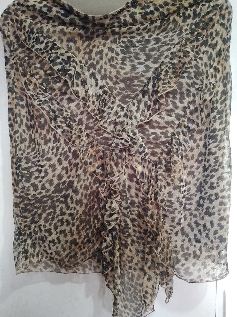Morgan de Toi Leopard Print Ruffle Blouse (Category: Blouses) located in Manila. Submitted by romeoamoro00044 (Listing ID 1469992720, Image 3). Description: - Brand: Morgan de Toi - Design: Brown and black leopard print sheer chiffon overlay with built-in lining - Details: Statement cascading front ruffles and an asymmetrical pointed hemline - Neckline: Boat neckline - Style: Authentic Y2K fashion piece - Condition: Great pre-loved condition.