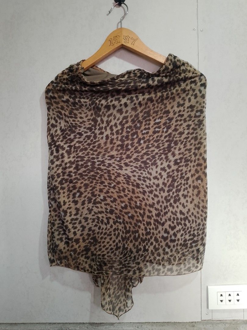 Morgan de Toi Leopard Print Ruffle Blouse (Category: Blouses) located in Manila. Submitted by romeoamoro00044 (Listing ID 1469992720, Image 2). Description: - Brand: Morgan de Toi - Design: Brown and black leopard print sheer chiffon overlay with built-in lining - Details: Statement cascading front ruffles and an asymmetrical pointed hemline - Neckline: Boat neckline - Style: Authentic Y2K fashion piece - Condition: Great pre-loved condition.
