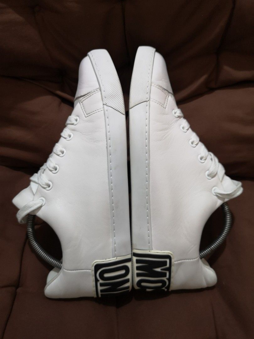 Moschino Maxi Logo White Leather Sneakers (Category: Sneakers) located in Manila. Submitted by lorenzomar99185 (Listing ID 1470018086, Image 1). Description: - Brand: Moschino - Color: Crisp White with Bold Black Logo - Style: Low-top, lace-up street style sneaker - Details: Eye-catching black lettering logo on the back rubber sole - Condition: Clean and ready for daily rotation - Size: EU 44 on tag / Best fit US 10.5 ~ 11.