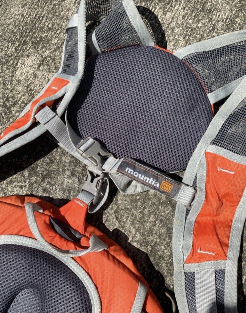 Mountaim Hiking Backpack Daypack (Category: Backpacks) located in San Fernando. Submitted by pearlys3lls (Listing ID 1470108994, Image 2). Description: - Brand/Model: Mountia Hiking Backpack - Color: Bright Orange and Grey - Comfort: Mesh padded back panel for superior breathability - Organization: Multiple zippered compartments and front pouches - Fit: Adjustable harness straps with quick-release buckles - Ideal for: Day hikes, outdoor excursion
