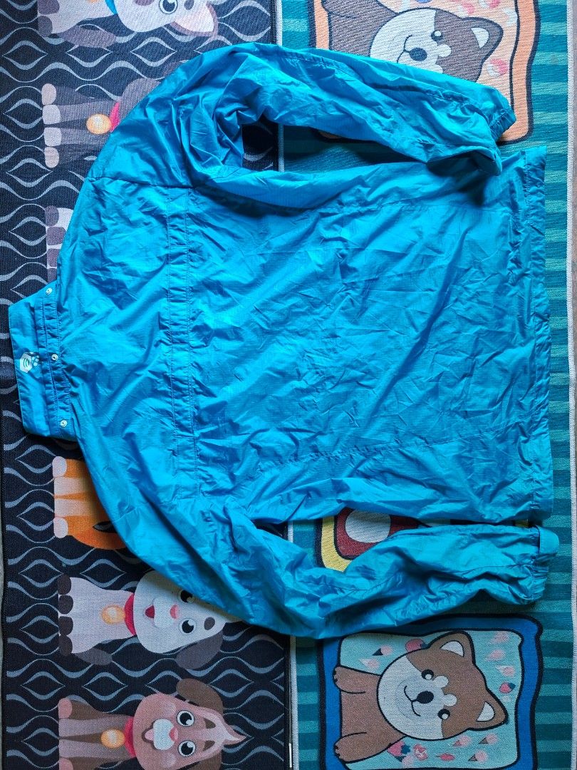 Mountain Hardwear Blue Windbreaker Jacket Size M (Category: Coats, Jackets and Outerwear) located in San Francisco. Submitted by manu2025 (Listing ID 1470140608, Image 2). Description: - Brand: Mountain Hardwear - Color: Blue with dark blue contrast chest pocket - Size: Medium (Tag 95 | Pit to pit: 21-22 inches) - Material: Lightweight windbreaker fabric - Features: Full front zip, high collar, secure zippered chest pocket - Condition/Use: Great 